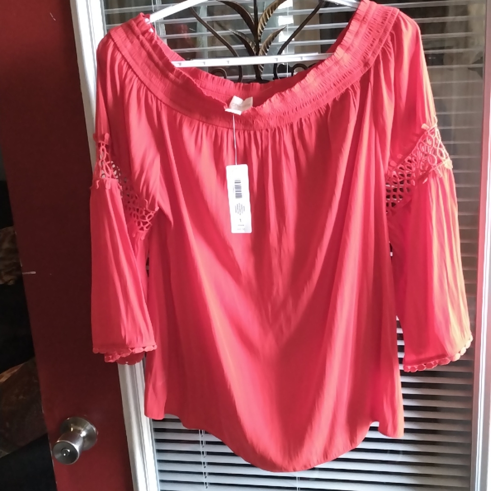 It is a ladies Chico brand size one the color is runaway red it is new with tag